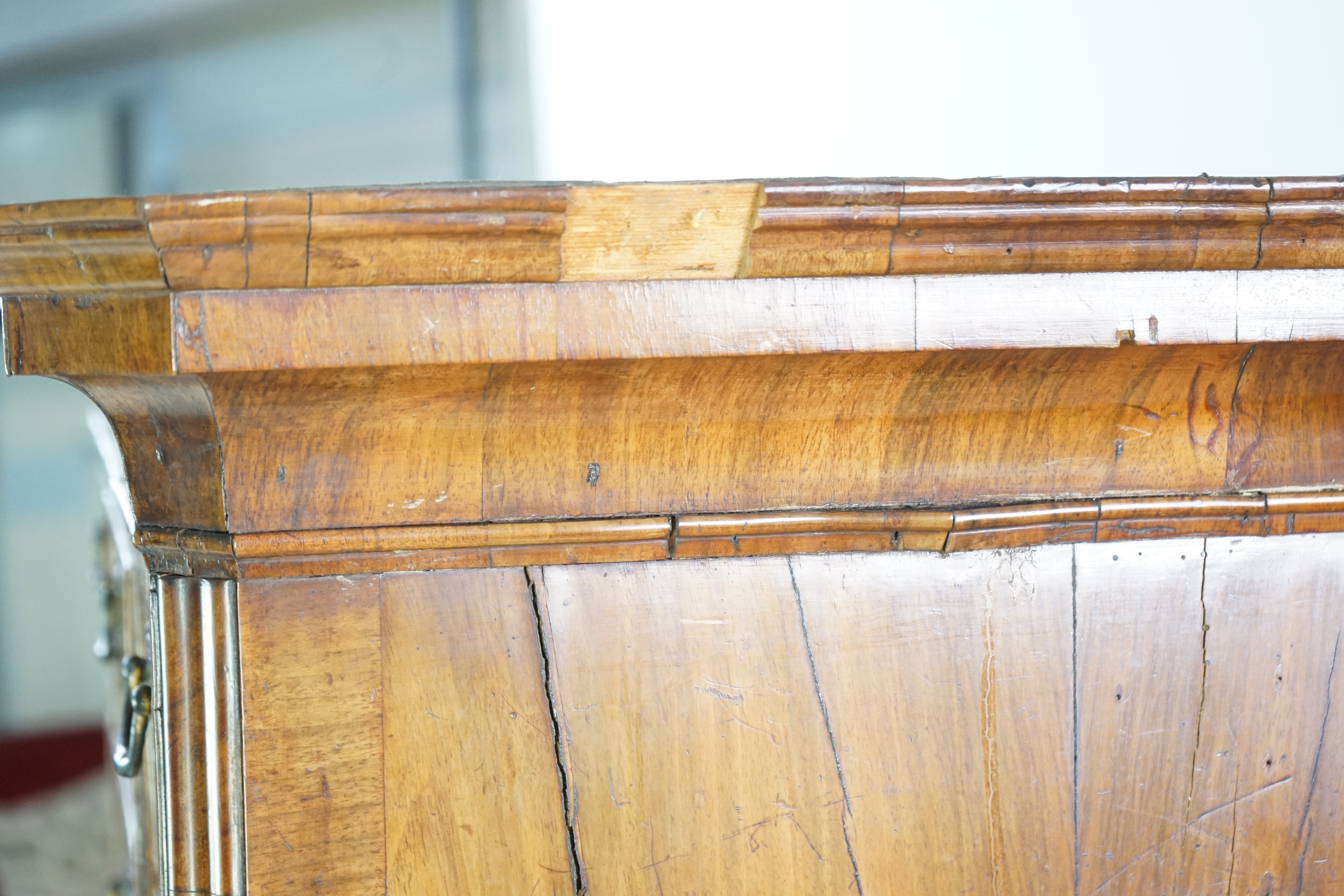 A George II feather banded walnut chest on chest